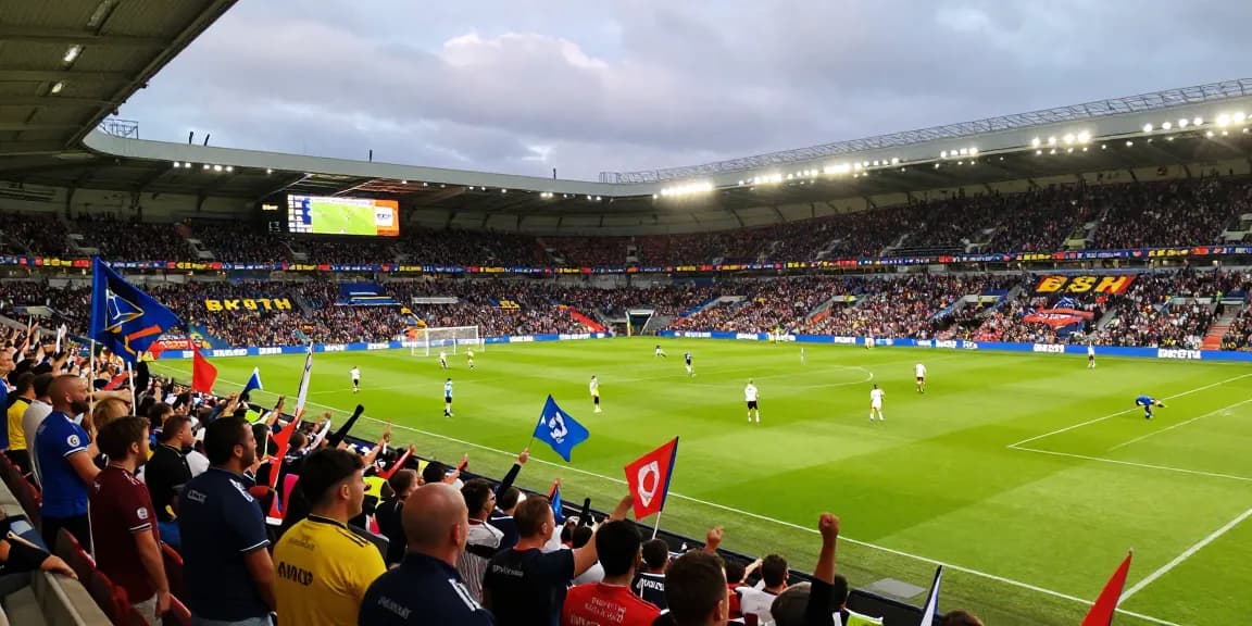 Exciting Premier League match at a stadium with fans supporting BK8TH.